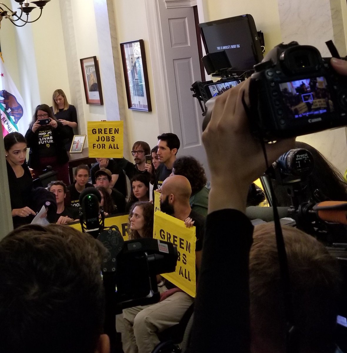 Alexandria Ocassio-Cortez in pelosi's office with sunrise