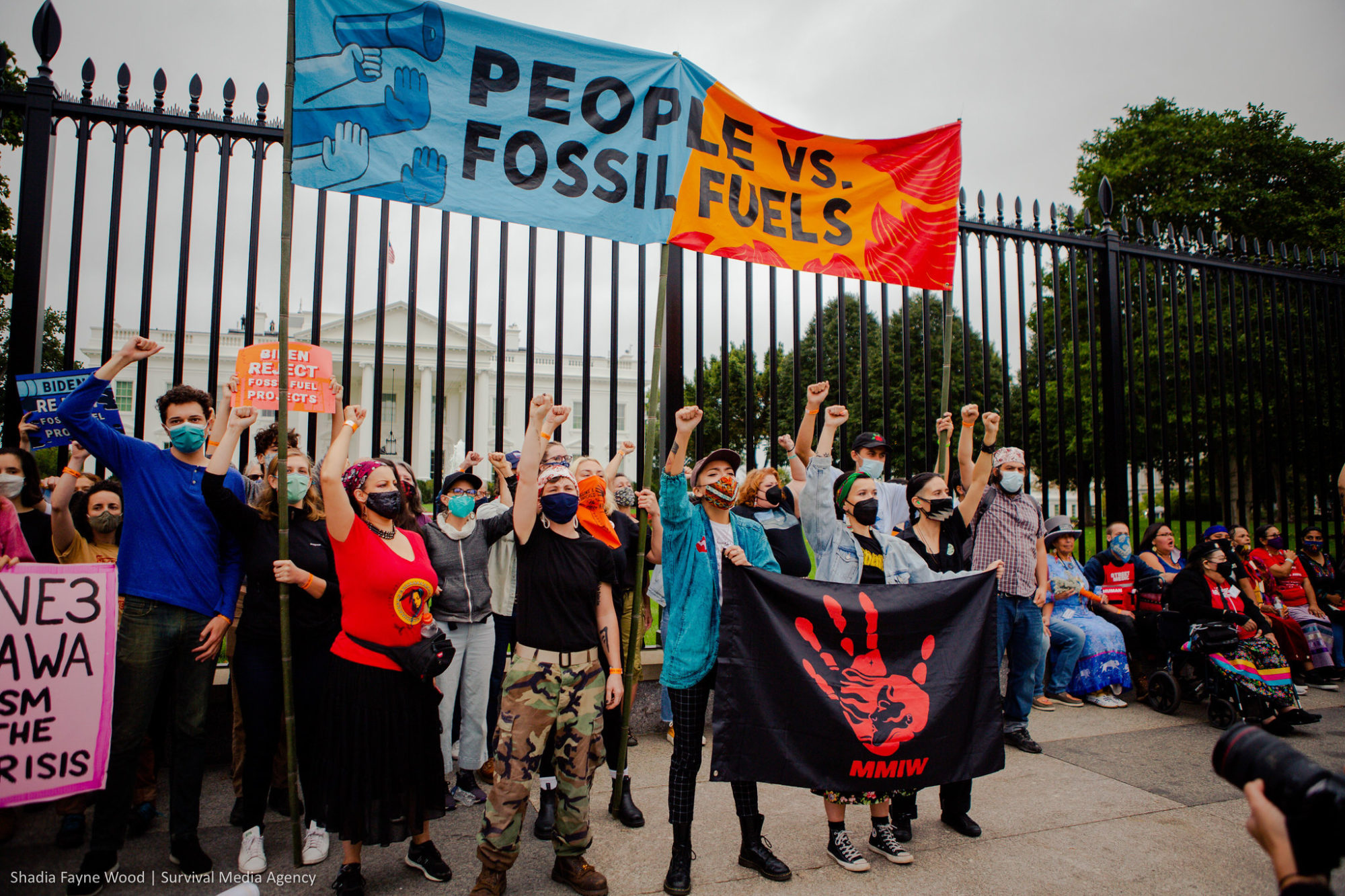 Indigenous leaders and allies with raised fists at the White House protest