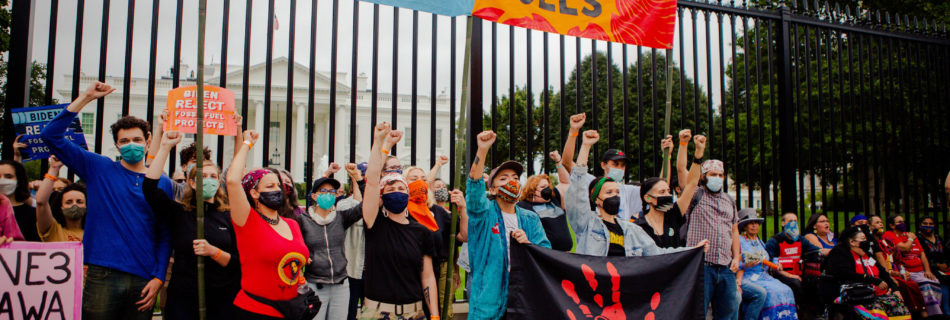 Indigenous leaders and allies with raised fists at the White House protest