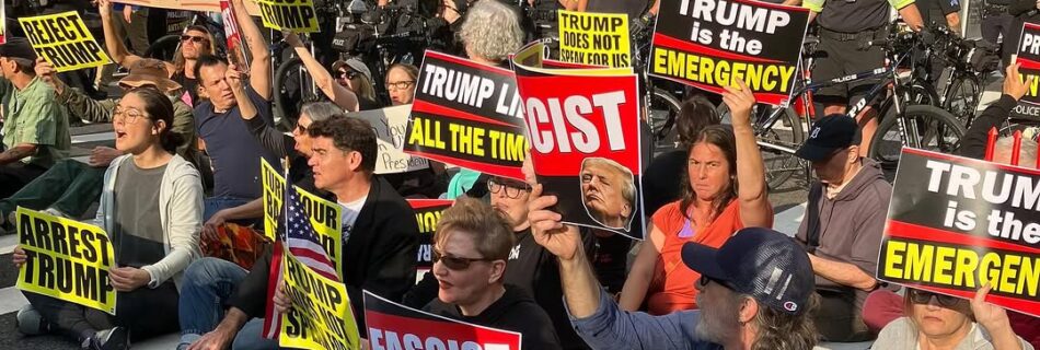 Rar and friends leading a sit in on 42nd street in new York city. Folks are sitting in the crosswalk to block Trump's motorcade and holding signs and banners denouncing Trump as a fossil fueled fascist.