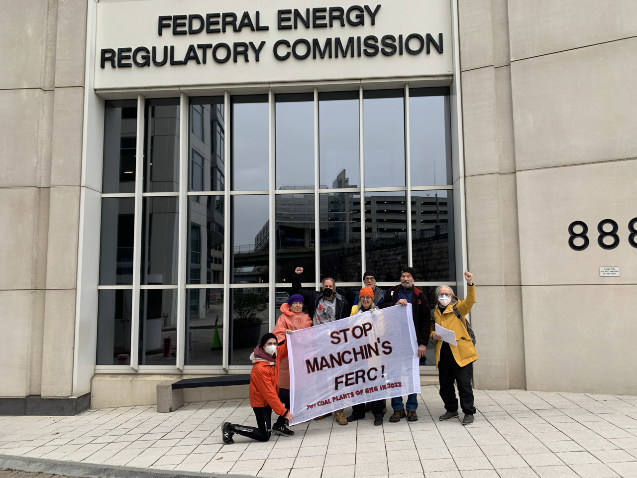 A group holds a stop Manchin's FERC banner outside the Federal Energy Regulatory Commission