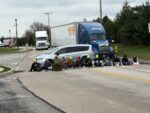 Starbucks workers in York PA sit down in the road, blocking a huge semi truck behind them